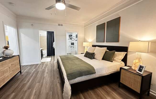 a bedroom with a bed and a ceiling fan