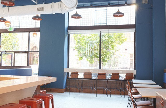 a restaurant with blue walls and a large window