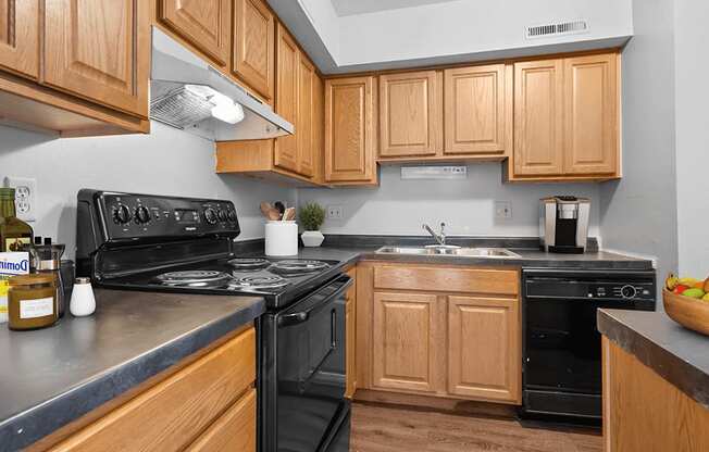 a kitchen with wood cabinets and black appliances