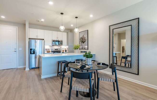 a dining room and kitchen with a table and chairs