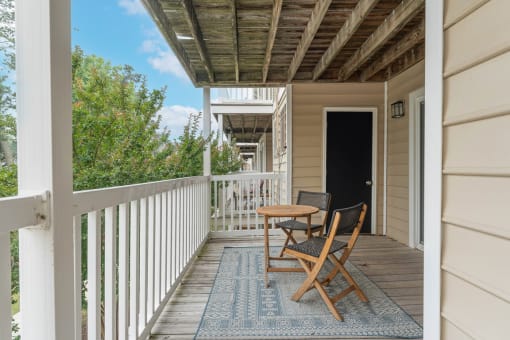a small table and two chairs on a porch at Linkhorn Bay Apartments, Virginia Beach, VA