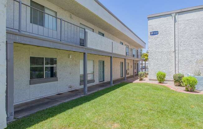 Apartment building with a green lawn in front.