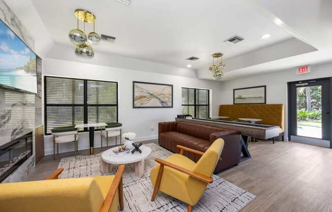 a living room with couches and chairs and a pool table