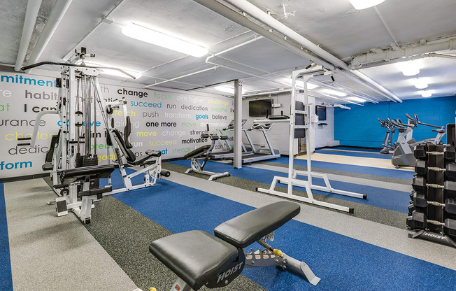 Fitness center with treadmills, machines and free weights at Mason Hall in Alexandria, VA 22314