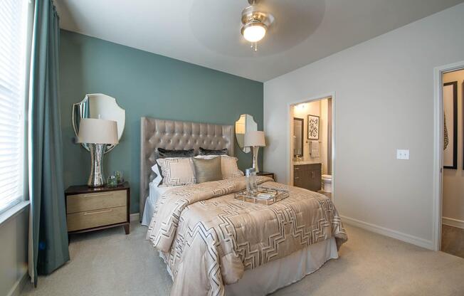 a bedroom with a bed and a mirror in a room