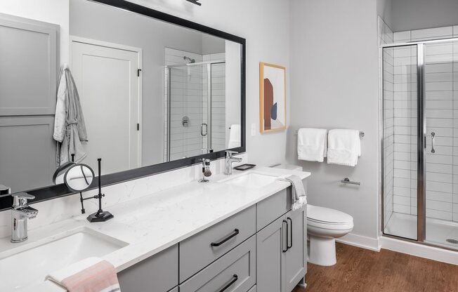 Designer bathroom with grey shaker cabinets and double vanity