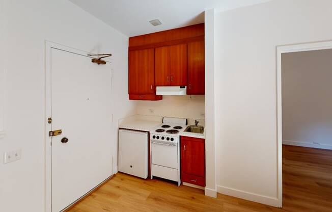 a kitchen with a stove top oven next to a doorway