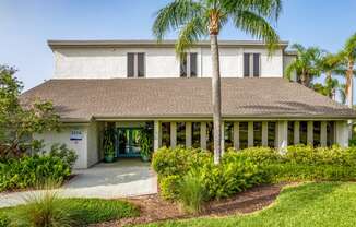 a house with palm trees in front of it