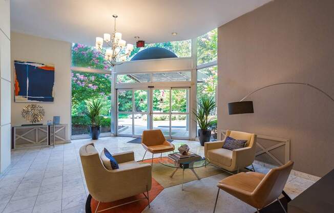 A living room with a glass table and chairs.