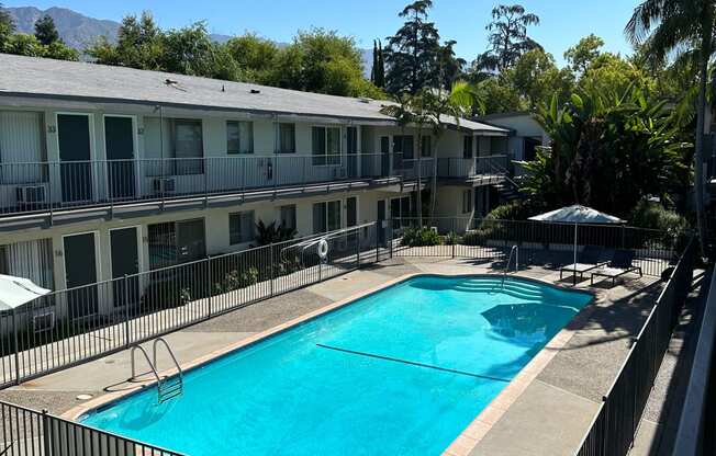 View of swimming pool and sun deck at Los Robles Apartments in Pasadena, California.