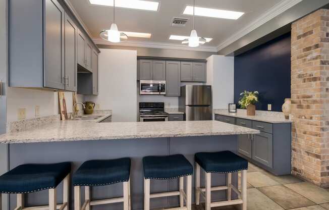 Clubhouse kitchen with a marble counter top and blue cabinets