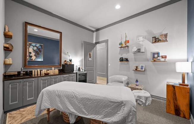 A bedroom with a bed, a nightstand, and a painting on the wall.