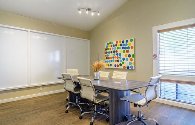 A conference room with a large table and chairs.
