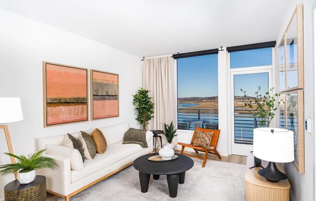 A bright living space with water views, warm finishes, and a seamless connection to your private balcony.
