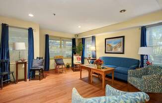 a living room with a blue couch and a table