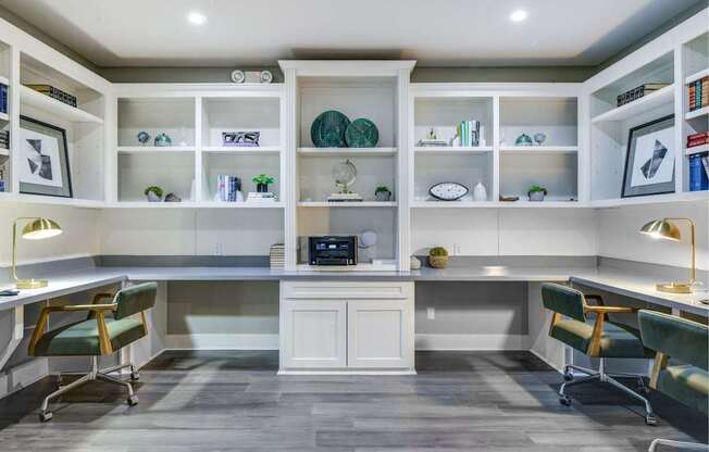 Business center with shared worktable seating, open shelving, and a bright, modern layout.