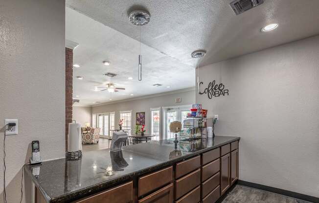 A coffee bar area with a counter and a wall sign.