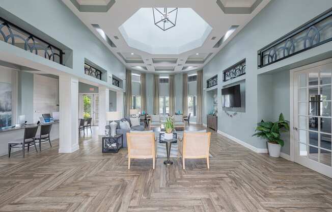 a large room with a table and chairs in the center of it