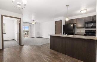 A kitchen area with a microwave, oven, and sink.