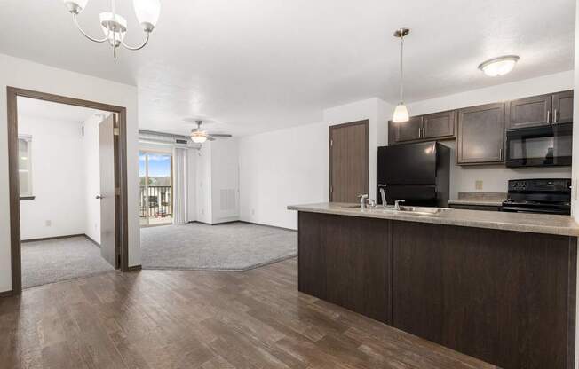 A kitchen area with a microwave, oven, and sink.