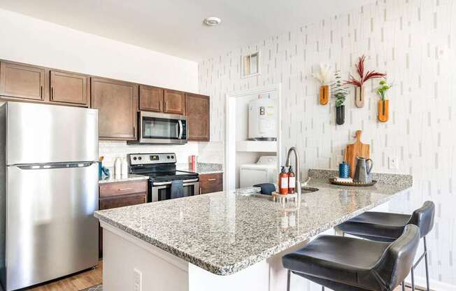A kitchen with a granite countertop and a refrigerator.