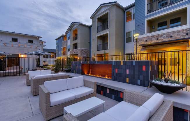 Outdoor Seating in Pool Area, Fireplace, Gates, and Cushioned Seating at Morgan Ranch Apartments, Morgan Hill, 95037