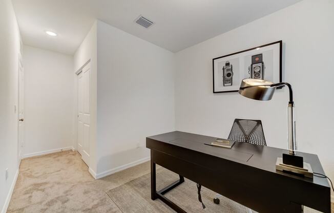 Boatman Hammock Townhomes in Lake Worth, FL photo of  a home office with a desk and a lamp and a white door