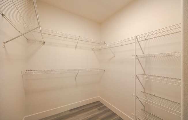 a spacious walk in closet at the whispering winds apartments in pearland, tx