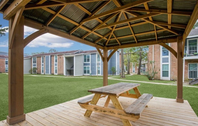 a picnic table on a deck in front of a building