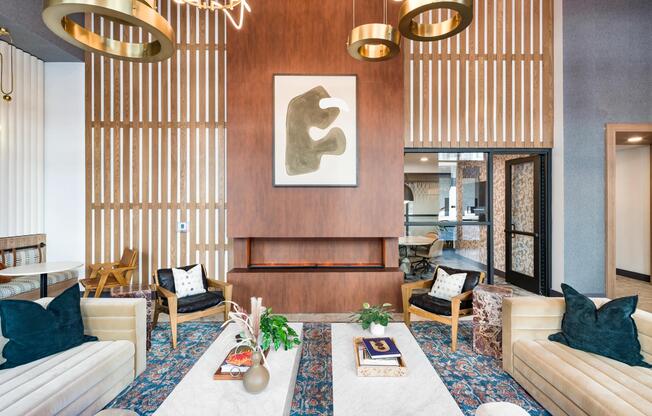 A refined resident lounge at Modera Higley Commons, where warm textures, layered lighting, and thoughtful design create an inviting place to gather.
