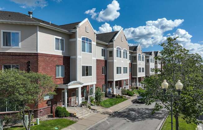 A row of townhouses with a tree in front of them.