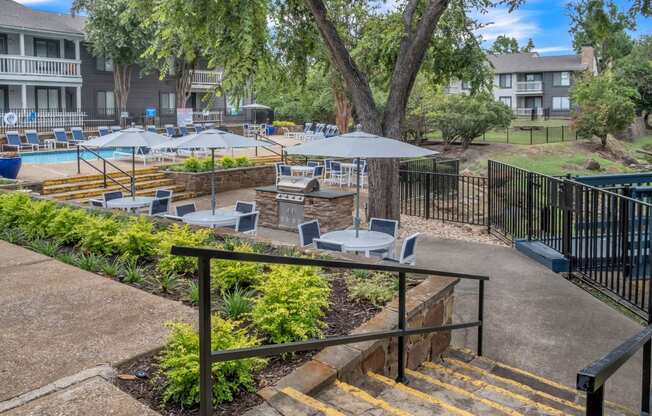 our apartments have a pool and patio with tables and umbrellas