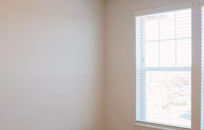 A room with a ceiling fan and a window.