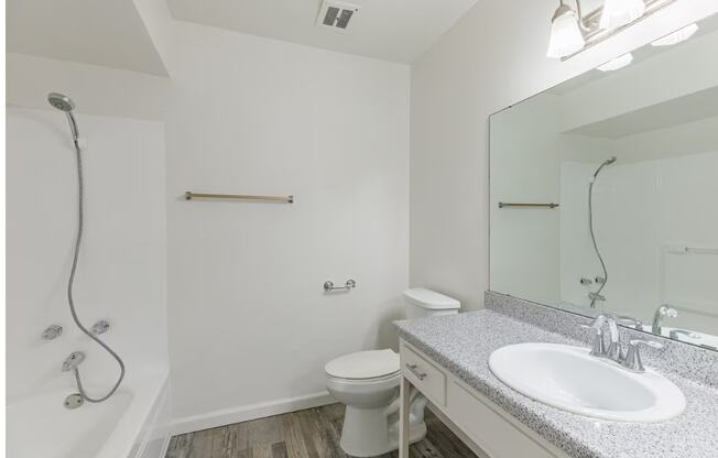 a bathroom with a toilet sink and bathtub