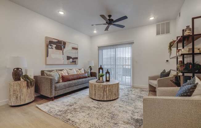 a living room with furniture and a ceiling fan