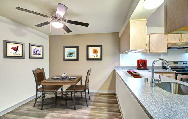 a dining room table with chairs next to a kitchen