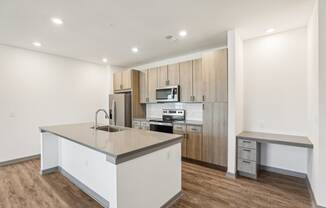 a kitchen with white cabinets and a large island with a sink at Drift, Daytona Beach, FL, 32117