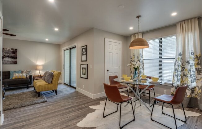 a dining room and living room with a table and chairs