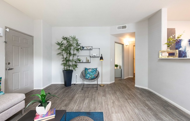 a living room with a couch and a chair and a plant