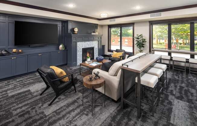 Clubhouse interior with lounger area and fireplace at The Whitley in St. Paul, MN.
