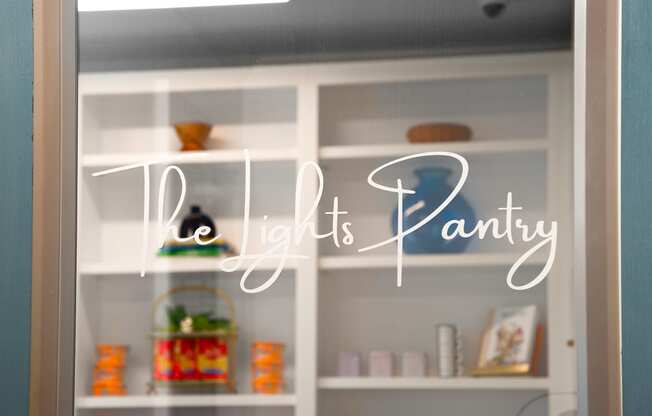 a window with the light it is pantry written on it