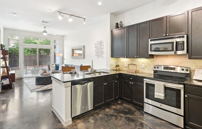 Model kitchen with stainless steel appliances at Harlow River Oaks in Houston, TX