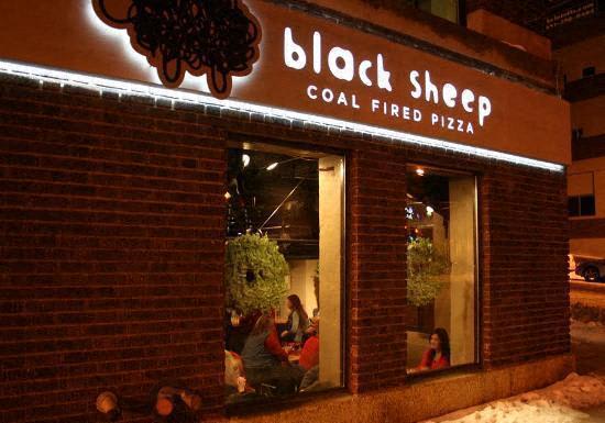 A brick building with a sign that says Black Sheep Coal Fired Pizza.