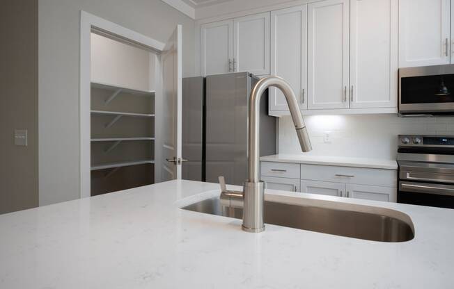 a kitchen with white cabinets and a white counter top