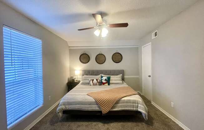 a bedroom with a large window and a ceiling fan  at 2151 Kirkwood, Houston, TX