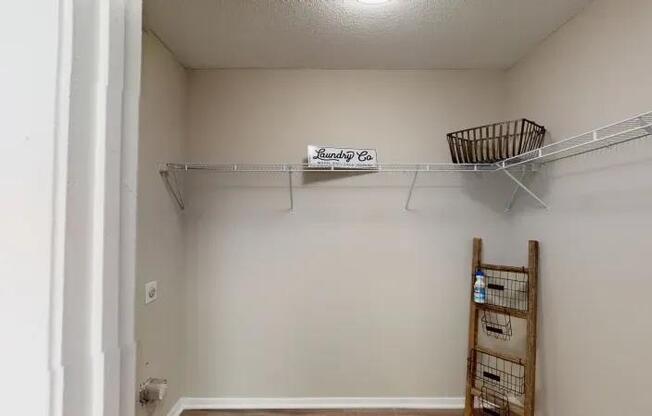 A small, white closet with a sign that says