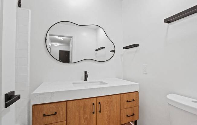 a bathroom with a white sink and a mirror