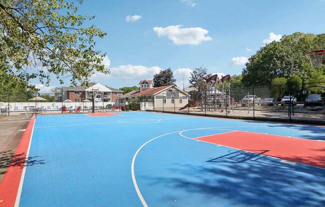 A basketball court with a blue surface and red boundary lines.