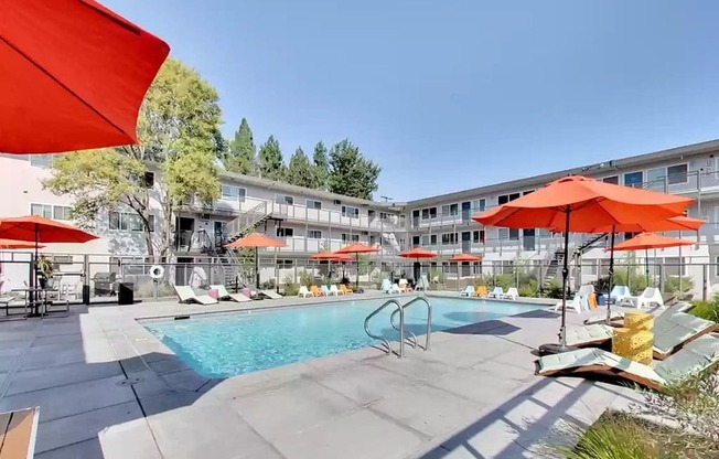 pool area with umbrellas and lounge seating at THE POST Apartments, PLEASANT HILL 