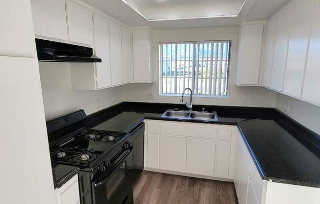 Kitchen with plank style flooring and great natural light at Northwood Apartments in Upland, California.